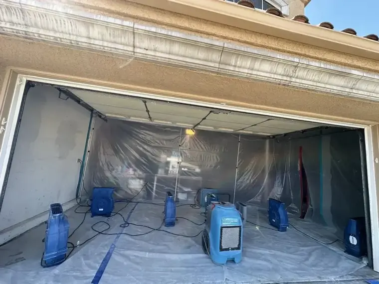 Garage sealed in plastic with dehumidifiers and air movers running in Escondido