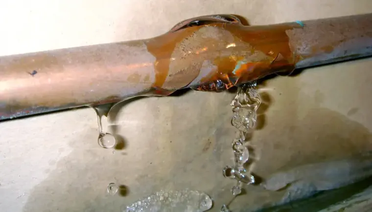 Corroded copper pipe dripping from a pinhole leak in Escondido
