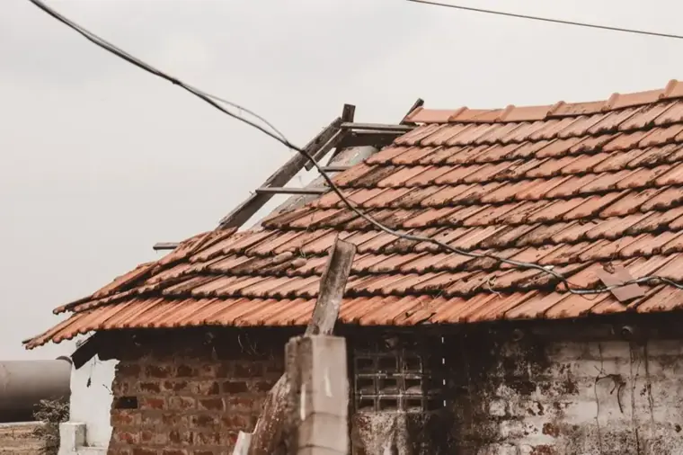 Weathered clay tile roof with broken and slipped tiles in Escondido