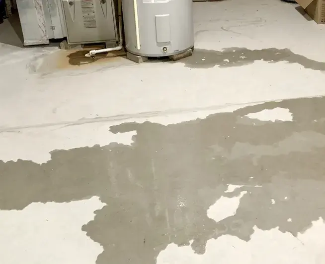 Water spreading across a garage floor from a failed water heater in Escondido